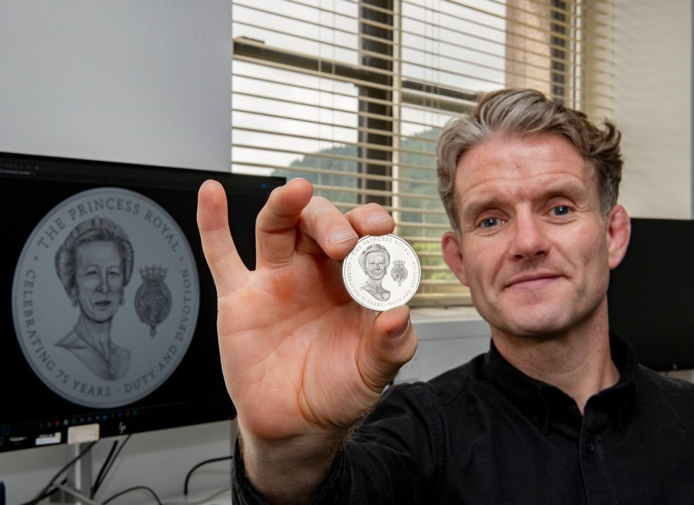 Royal Mint coin designer Thomas T Docherty holding the coin featuring the princess