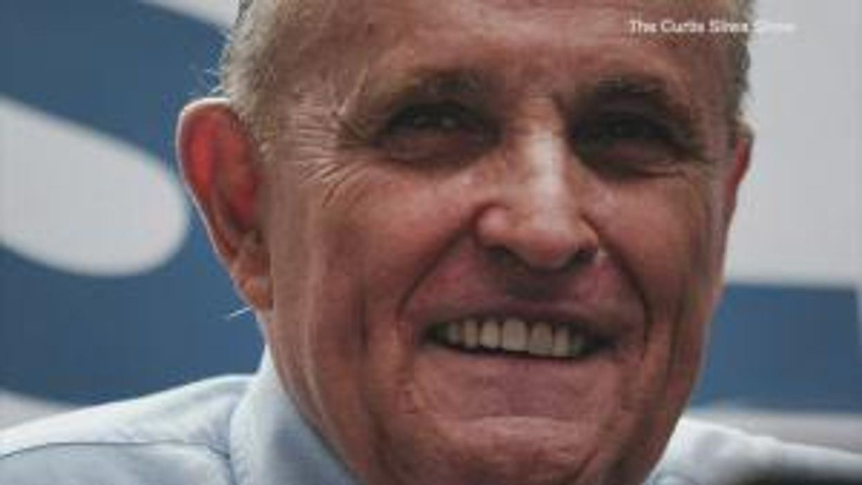 Rudy Giuliani 'slapped' on back and called a 'f***ing scumbag' by a supermarket employee