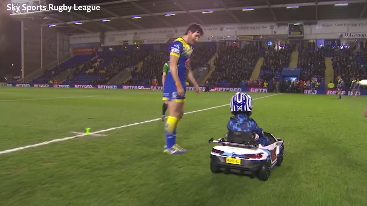 Small child driving an even smaller car at Rugby League game becomes instant icon