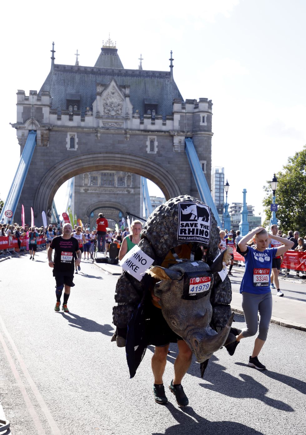 Runners in fancy dress cross over Tower Bridge (Steven Paston/PA)