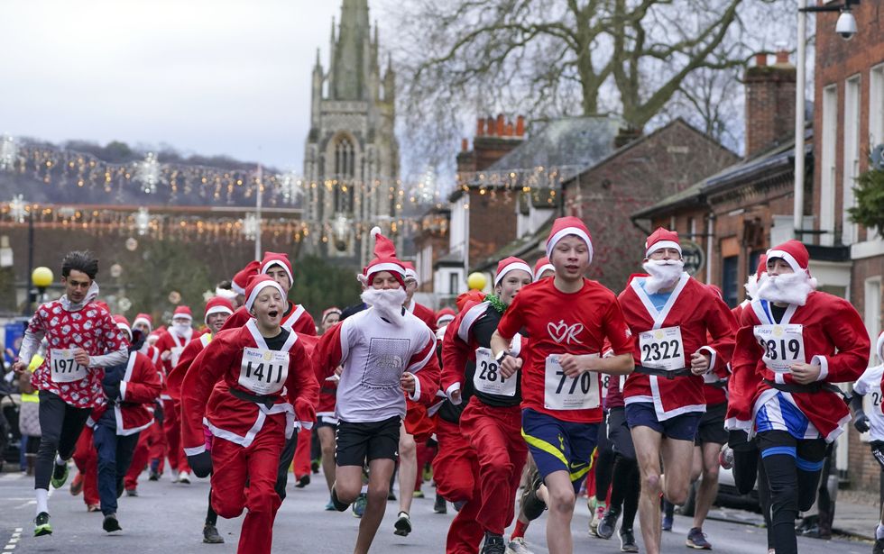 Runners take part in a Santa run in Marlow, Buckinghamshire (Steve Parsons/PA)