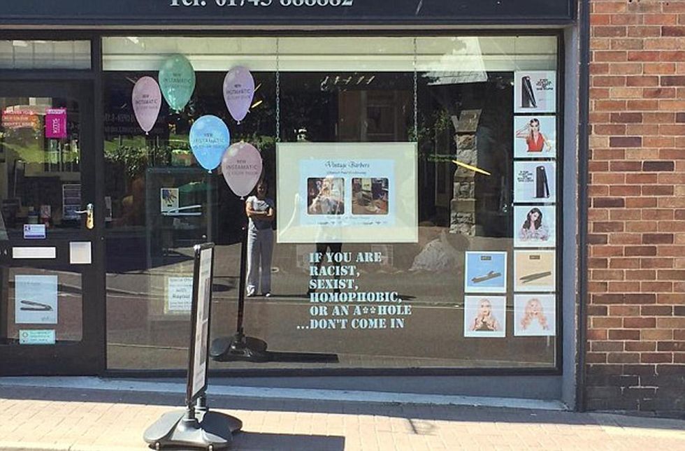 Russell Hughes, who owns Russell Paul Hairdressing in Prestatyn, put a sign in his salon window on Tuesday which reads: If you are racist, sexist, homophobic or an a***hole... don\u2019t come in