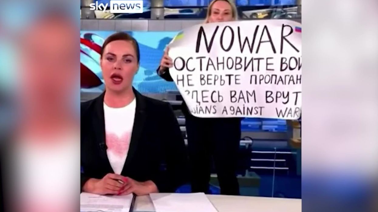 Russian anti-war protestor interrupts state TV news with 'they're lying to you' sign