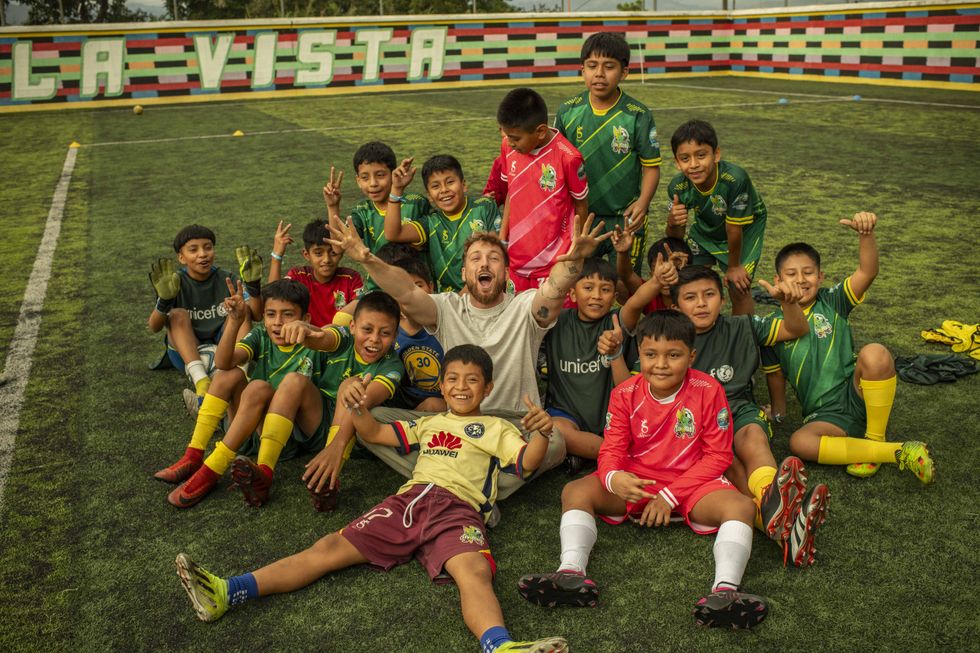 Sam Thompson joins boys and girls, aged nine to 12, to play football at Unicef-supported Juego Limpio Fair Play football programme supporting children in Solola, Guatemala