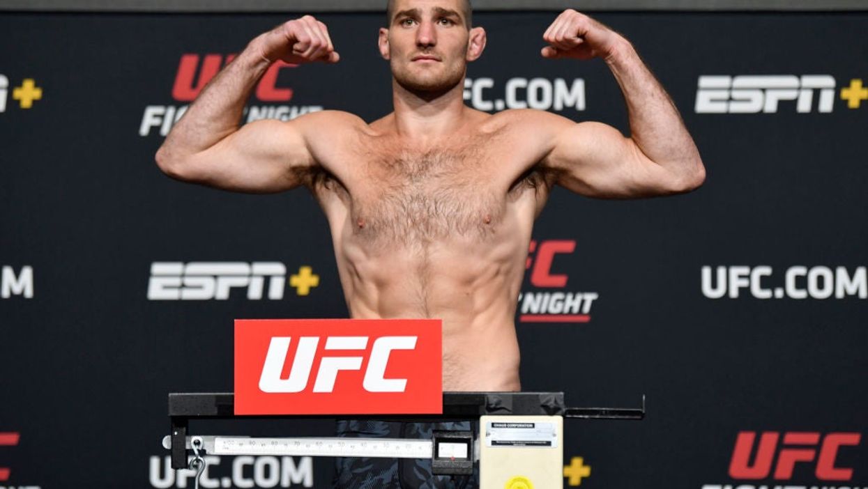 <p>Sean Strickland poses on the scale during the UFC weigh-in at UFC APEX in April </p>