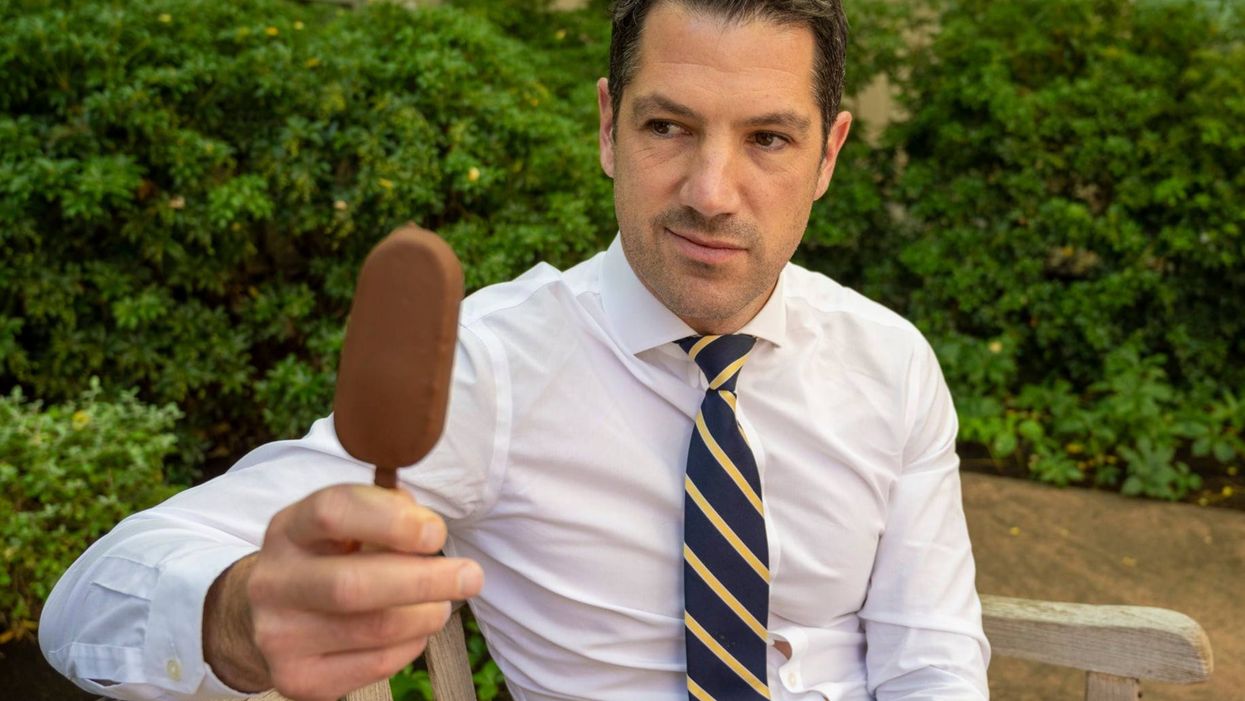 <p>Senator Alex Antic gazes at his beloved choc ice</p>