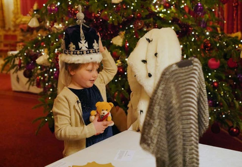 Seven-year-old Olivia Taylor, with her teddy bear Corrie, wearing a replica of the Queen Mary crown