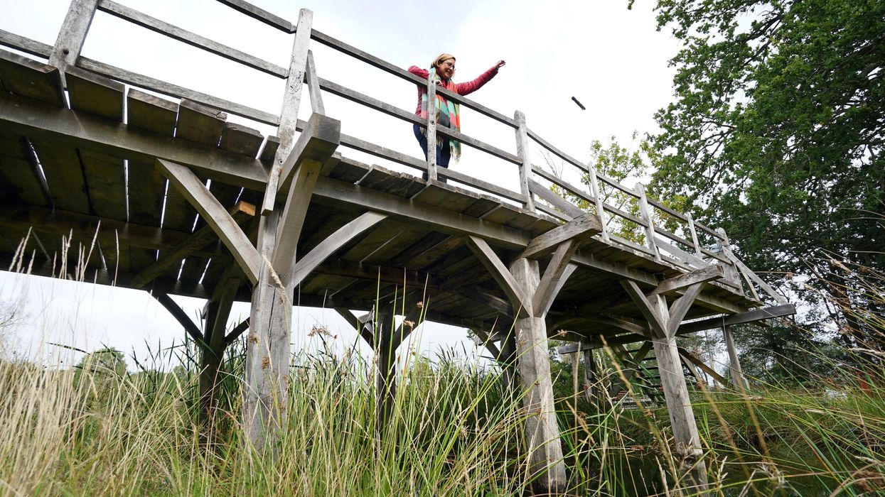 Silke Lohmann, of Summers Place Auctions, stands on the original Poohsticks Bridge from East Sussex’s Ashdown Forest, made famous in AA Milne’s Winnie the Pooh stories (Gareth Fuller/PA)