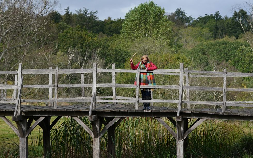 Silke Lohmann, of Summers Place Auctions, stands on the original Poohsticks Bridge in the Ashdown Forest (Gareth Fuller/PA)