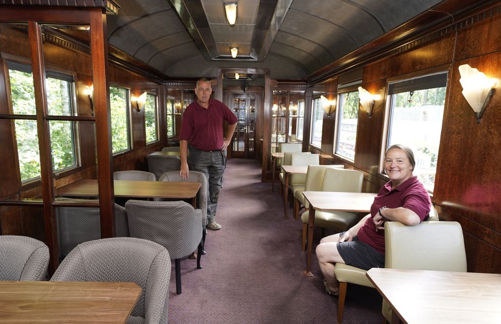 Simon and Diana Parums inside their full-size steam train in Keswick (Owen Humphreys/PA)
