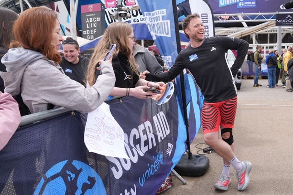 Singer Olly Murs meets supporters after he crossed the finish line