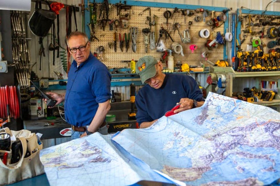 Sir David Hempleman-Adams (left) and American balloon manufacturer Bert Padelt examine a map spread across as table as they work on preparations for the Torabhaig Atlantic Explorer
