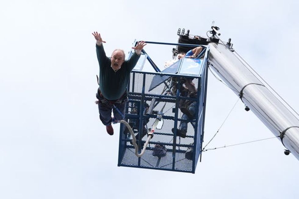 Sir Ed Davey takes part in a bungee jump
