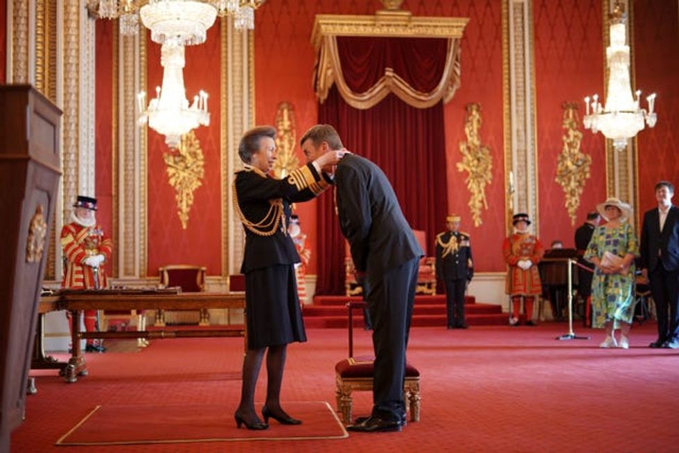 Sir Ian Rankin is knighted by the Princess Royal at Buckingham Palace