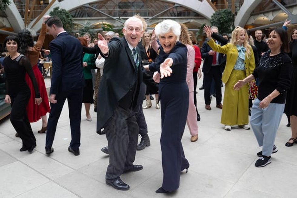 Sir Lindsay Hoyle, centre left, and Angela Rippon, centre right, posing with their arms out stretched in front of other dancing MPs and celebrities including Dame Arlene Phillips, Hannah Spencer and Flavia Cacace