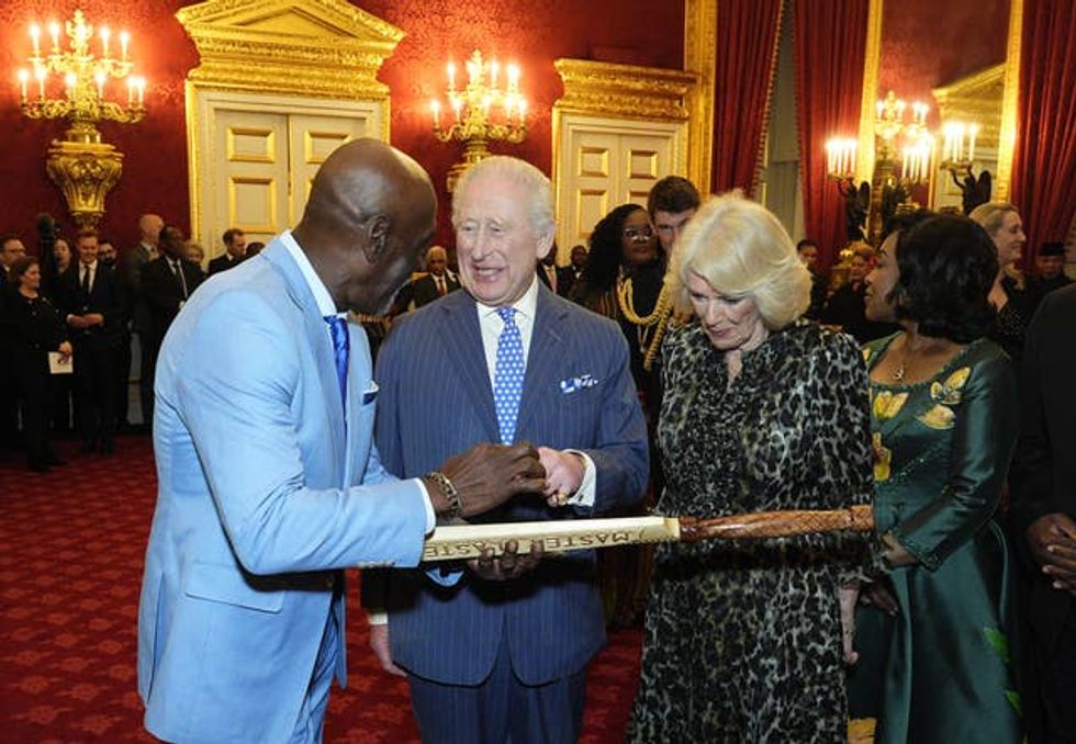 Sir Viv Richards gifts a cricket bat to the King and Queen during the annual Commonwealth Day reception at St James\u2019s Palace in London