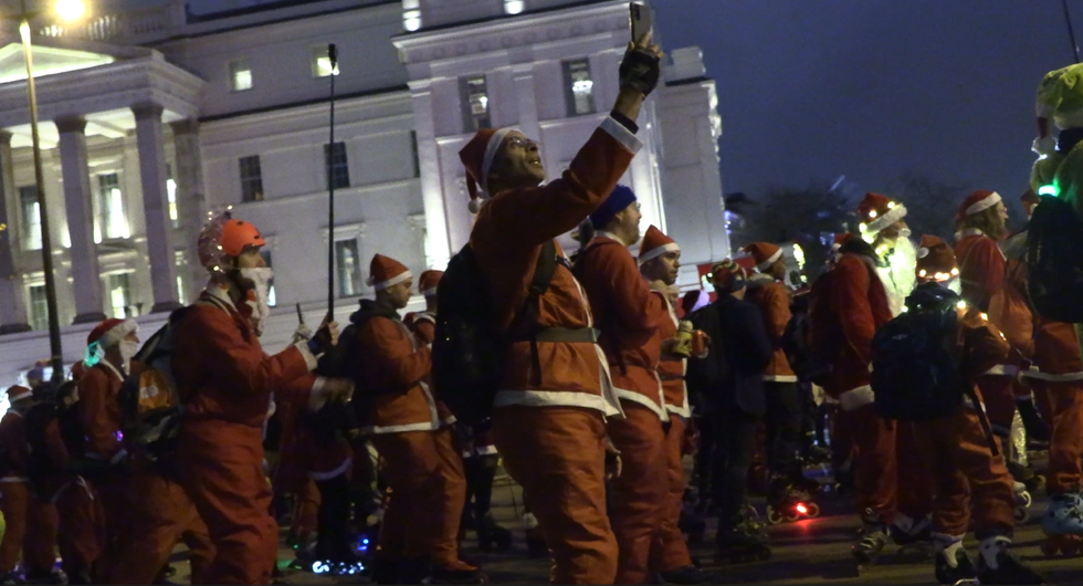 Skaters take over London streets wearing Santa outfits to provide festive cheer
