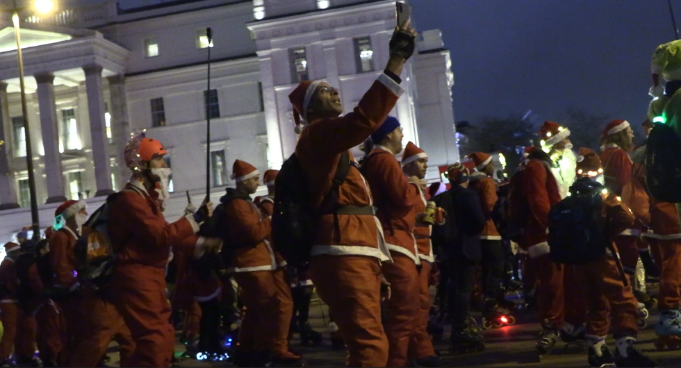 Skaters take over London streets wearing Santa outfits to provide festive cheer