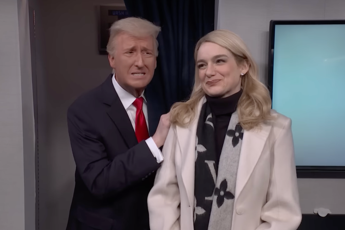 SNL skit. James Austin Johnson as Donald Trump and Ashley Padilla as Karoline Leavitt. Johnson is placing a hand on Leavitt's shoulder, who is smiling warmly.