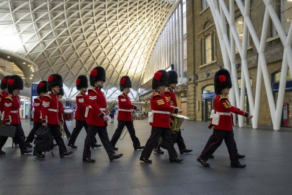 Soldiers march through the station
