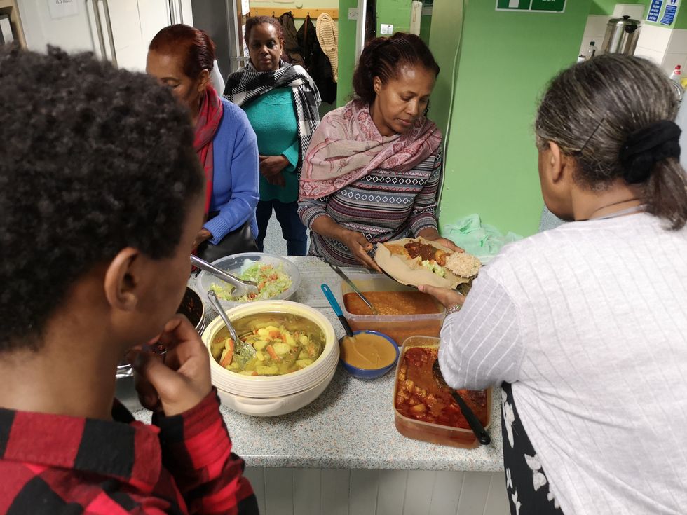 Staff and volunteers serving food at Injera Club (Da\u2019aro Youth Project/Benny Hunter/PA).