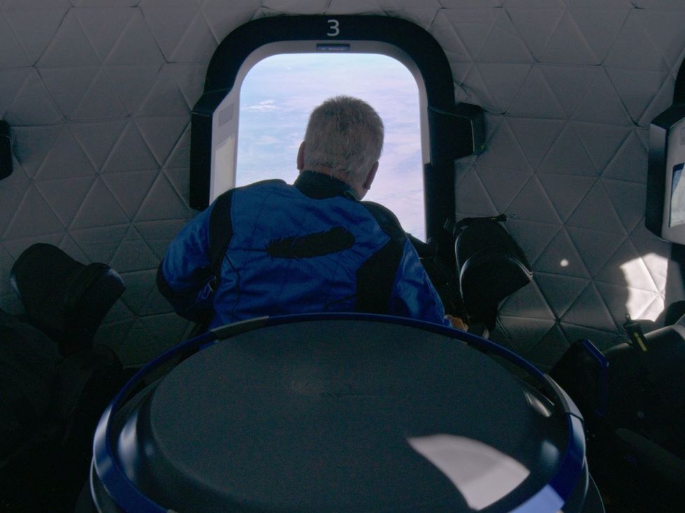 Star Trek actor William Shatner looks out a window during the Blue Origin New Shepard mission NS-18