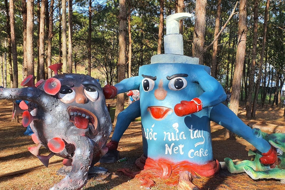 Statues in the Covid-19 Park in Vietnam show the virus being attacked by handwash