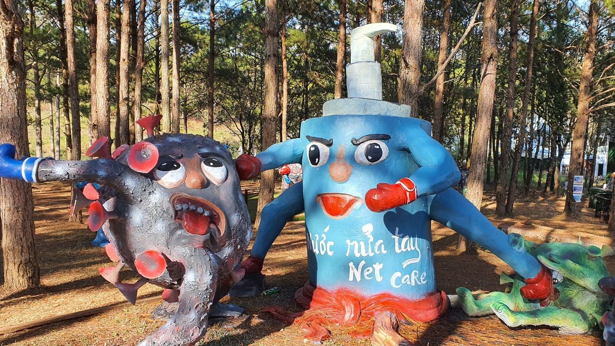 Statues in the Covid-19 Park in Vietnam show the virus being attacked by handwash