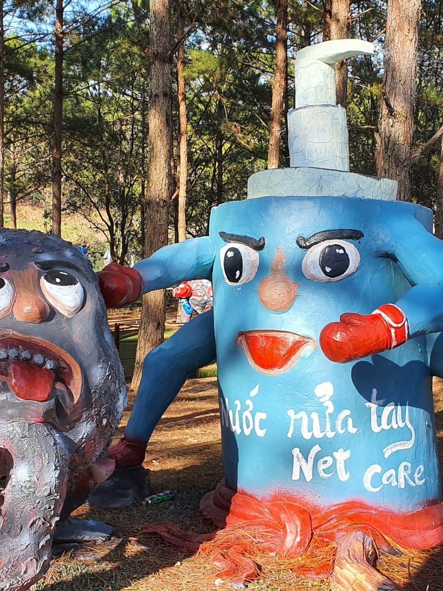 Statues in the Covid-19 Park in Vietnam show the virus being attacked by handwash