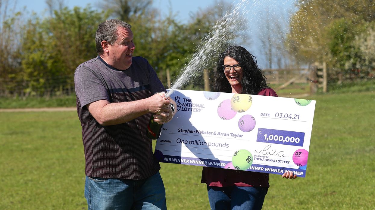 Stephen Webster and partner Arran Taylor celebrate his £1 million Lotto win (The National Lottery/PA).
