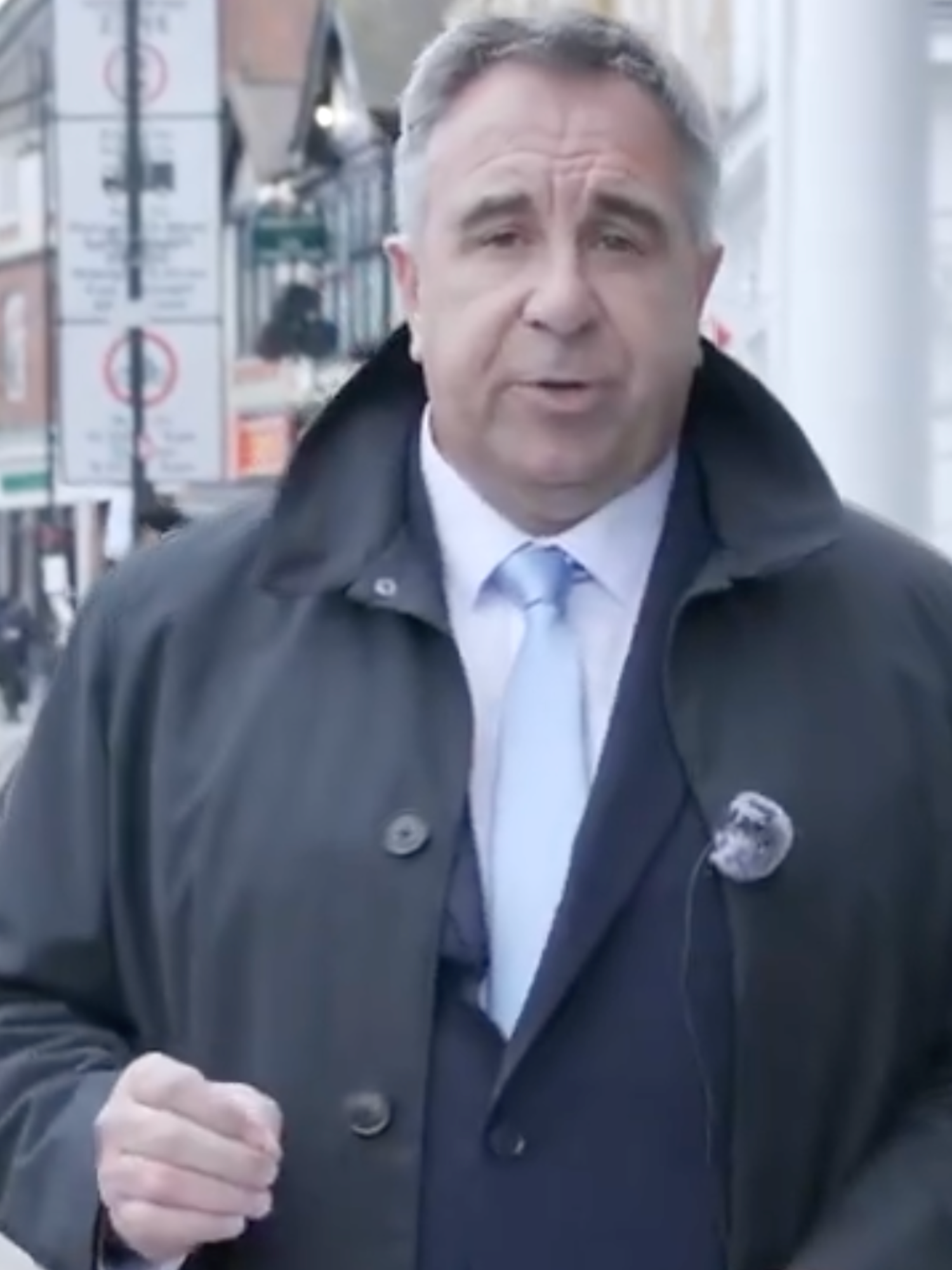 Steve Tuckwell, a white man with short grey hair and a black coat, addresses the camera.