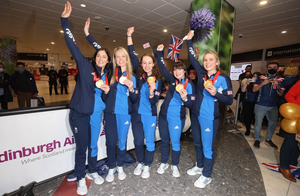 Triumphant Olympic curling teams land in Edinburgh