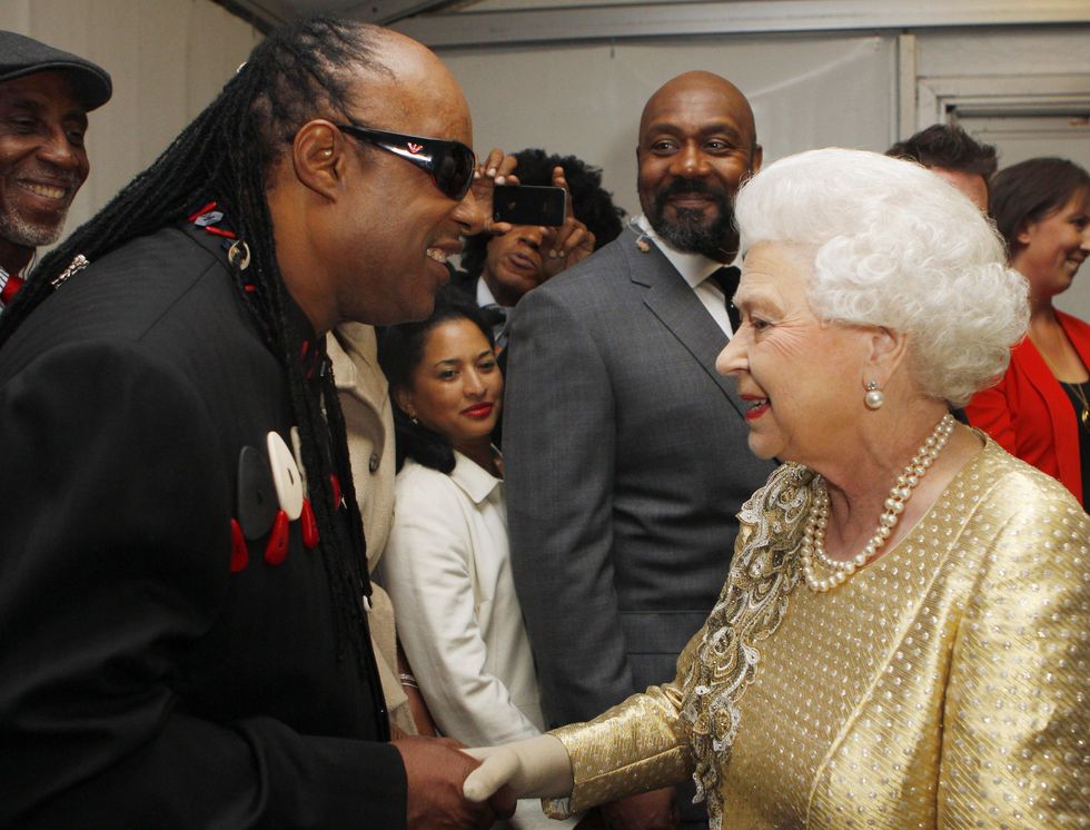 Stevie Wonder is introduced to the Queen backstage at the Diamond Jubilee Concert