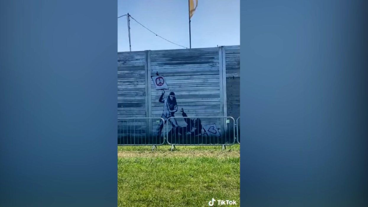 Original 2010 Banksy appears on fence at Glastonbury Festival