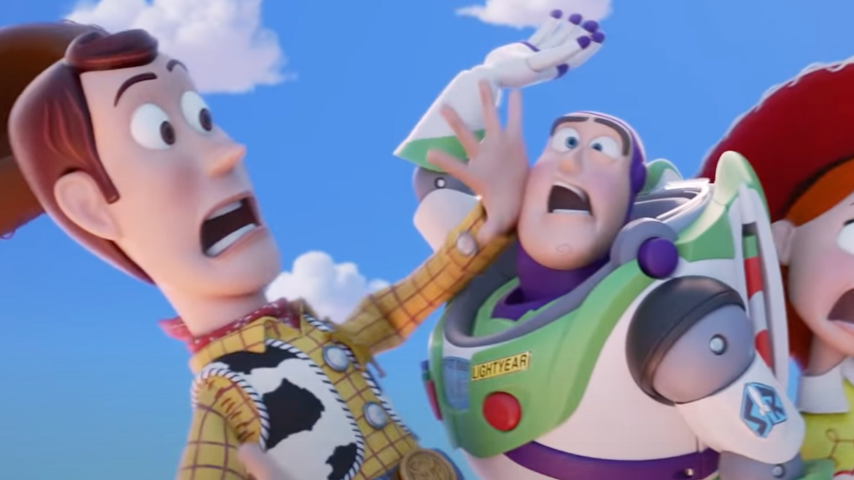 Still from an animated trailer for Toy Story, showing the cowboy Woody crashing into Buzz, a space ranger with a green and purple suit.
