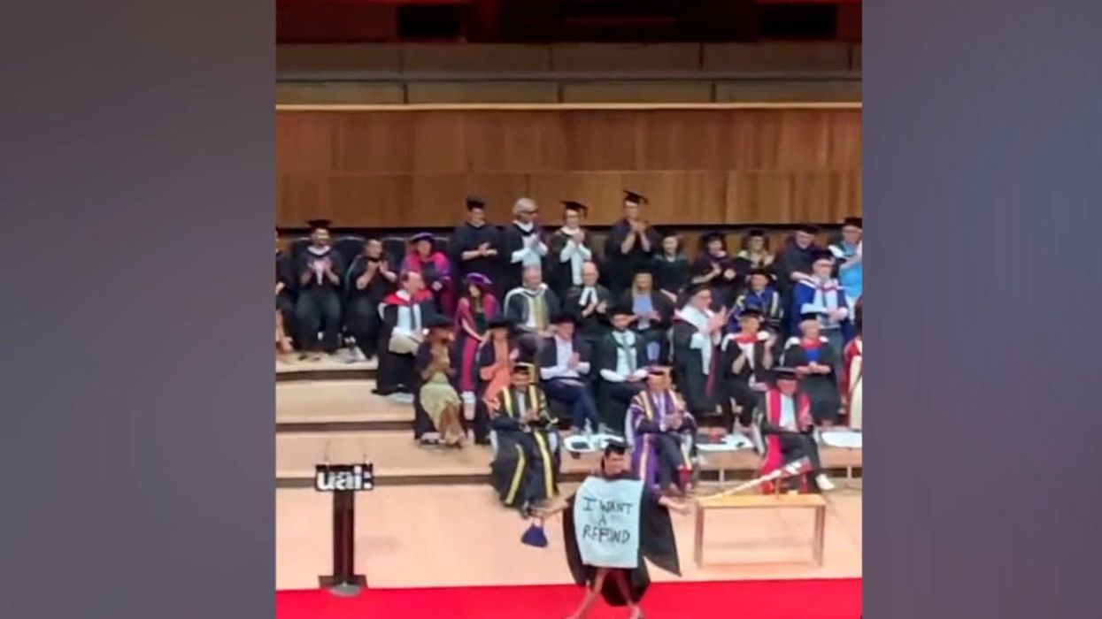 Student protests tuition fees by demanding refund on-stage at graduation