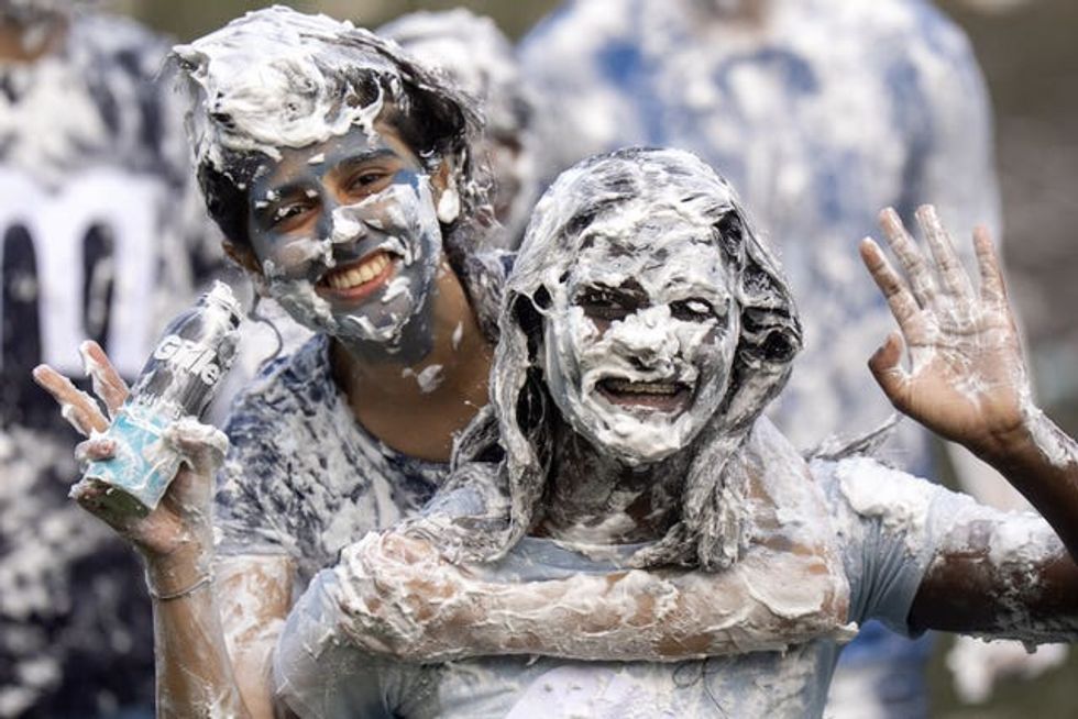Students take part in the traditional Raisin Monday foam fight