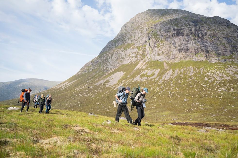 Students walking near a mountain