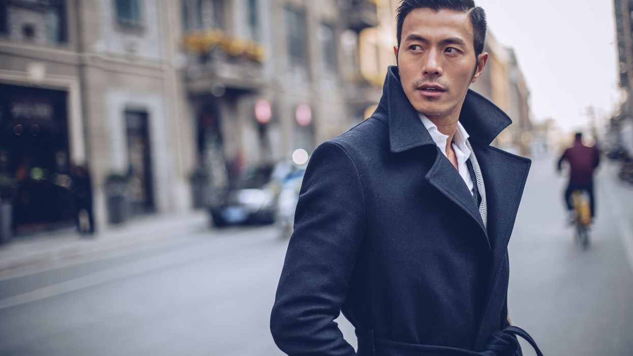 <p>Stylish man in a coat, standing on the street downtown.</p>