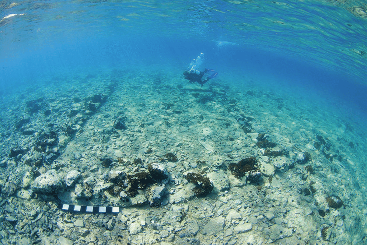 Submerged architectural remains at Pavlopetri, including the remains of a stone wall showing the outline of a rectangular building.