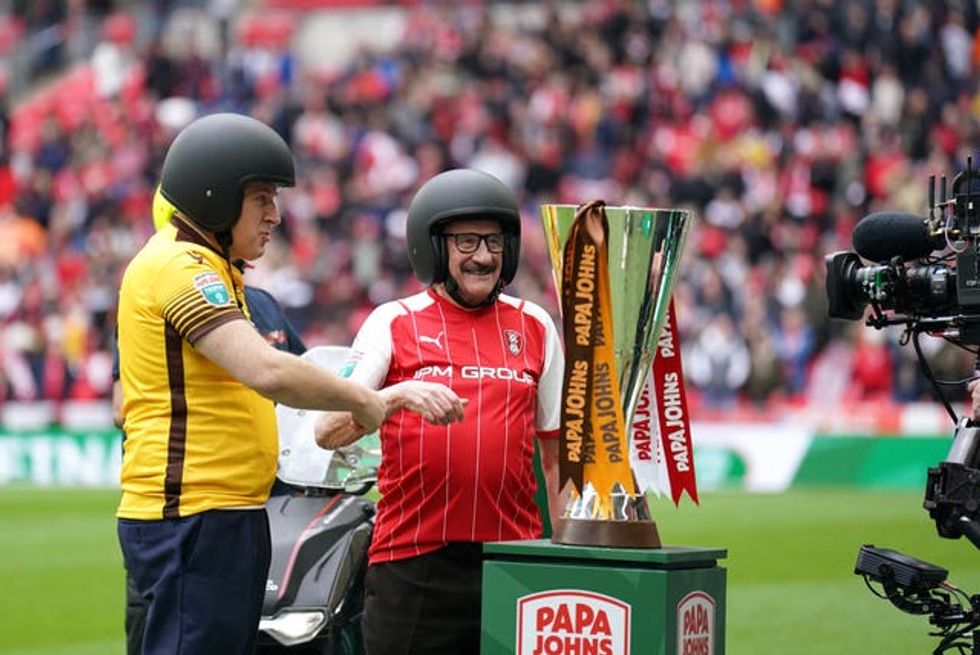 Sutton United fan Tim Vine and Rotherham United fan Paul Chuckle with the trophy before the Papa John\u2019s Trophy final