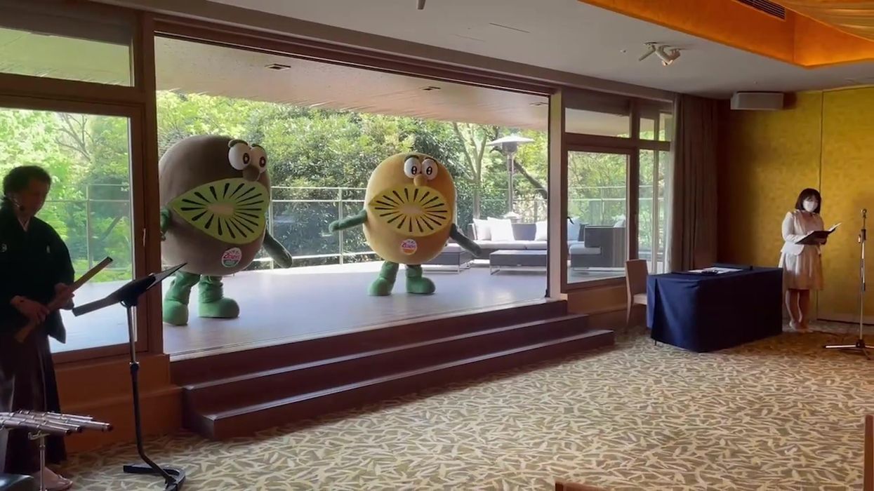 Jacinda Ardern greeted by giant dancing kiwifruits during visit to Japan