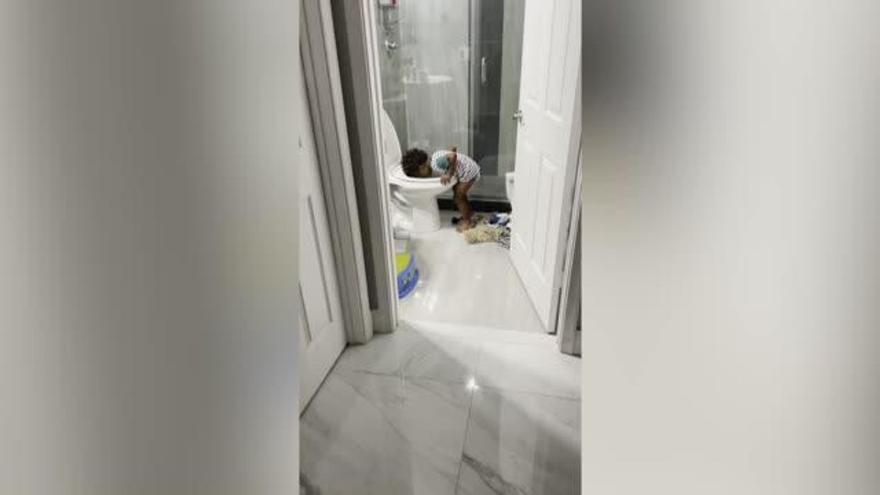 Sweet toddler copies pregnant mum suffering from morning sickness