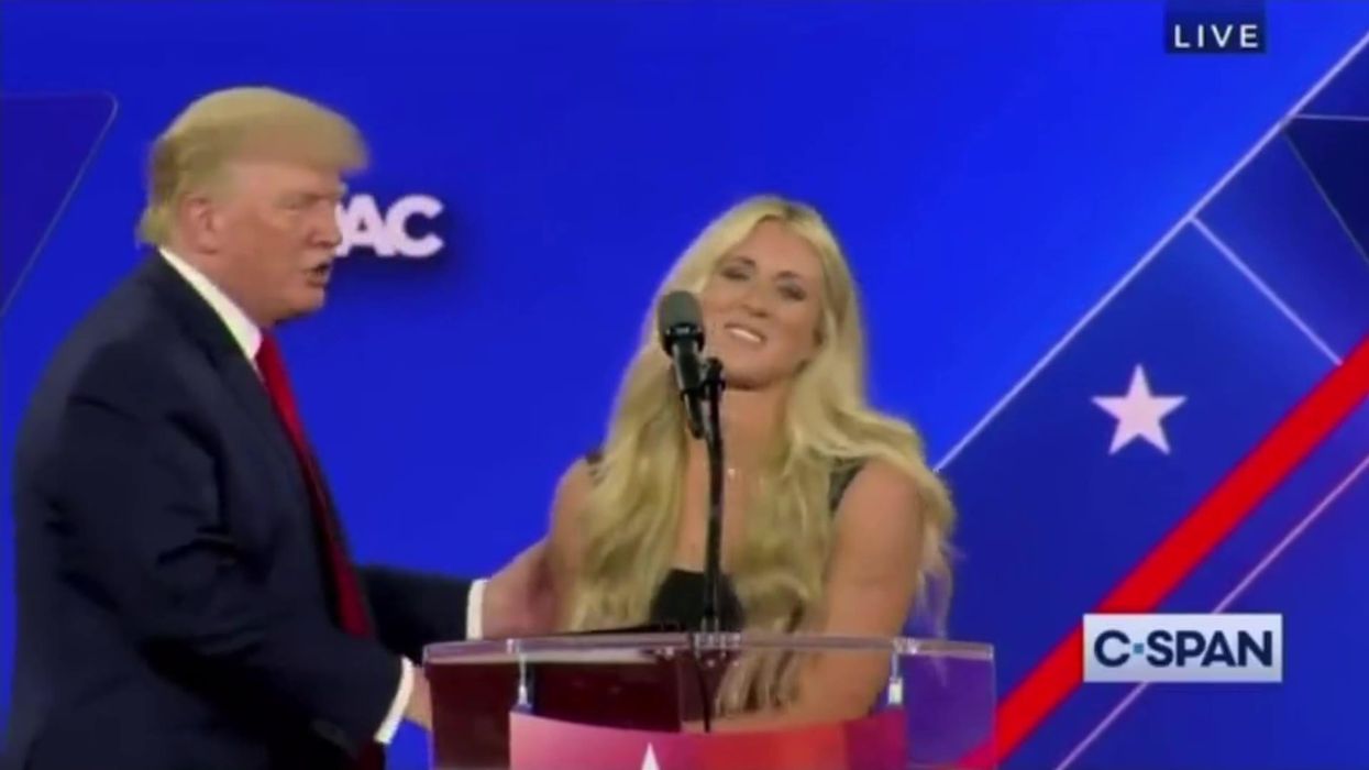 Swimmer appears to dodge Donald Trump as he tries to kiss her on stage at CPAC