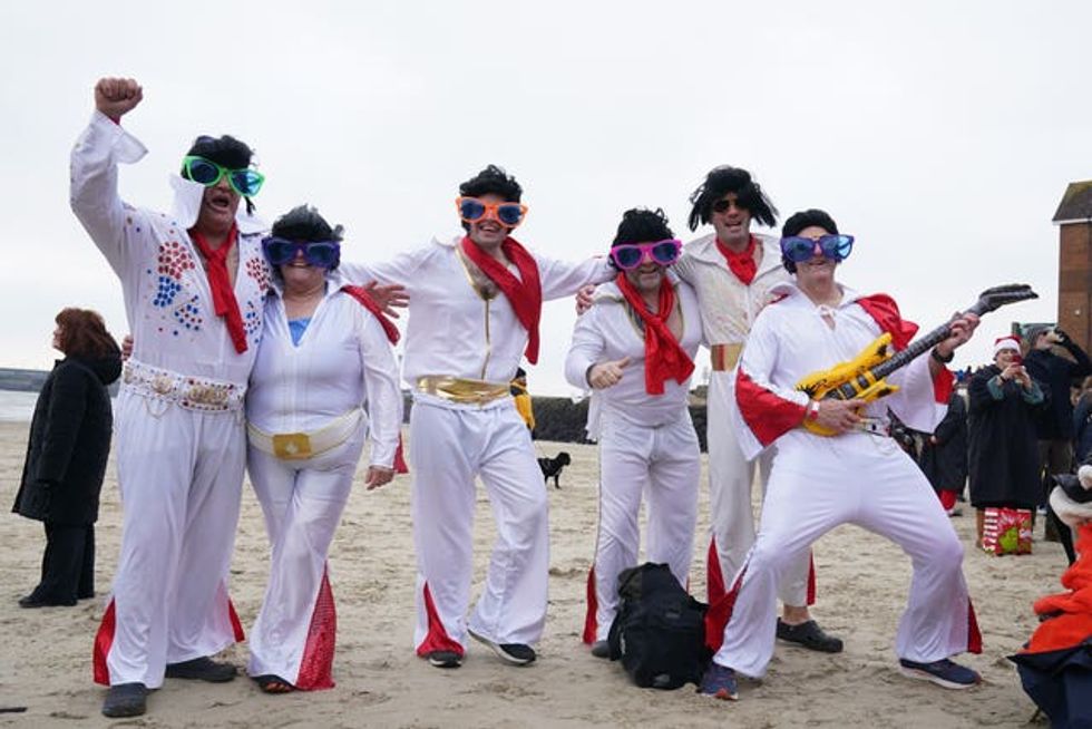 Swimmers dressed as Elvis take part in the Folkestone Lions\u2019 Boxing Day Dip at Sunny Sands Beach in Folkestone
