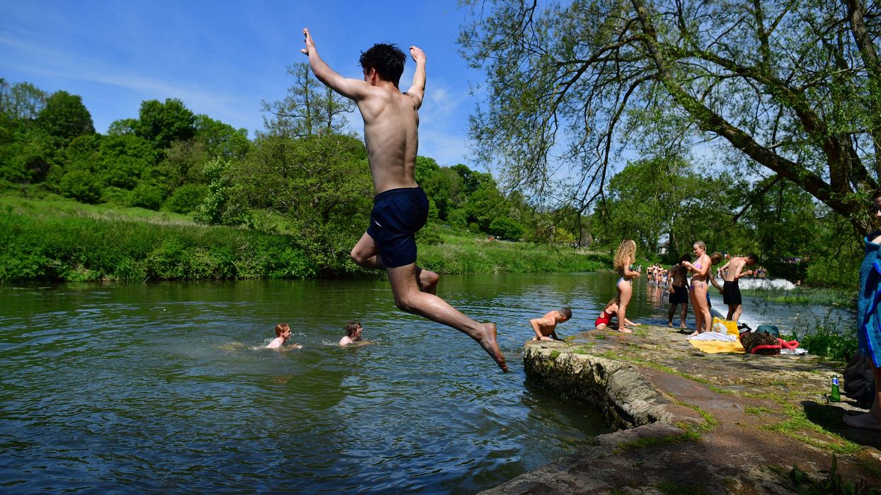 Swimmers enjoy the hot weather at Warleigh Weir, Bath