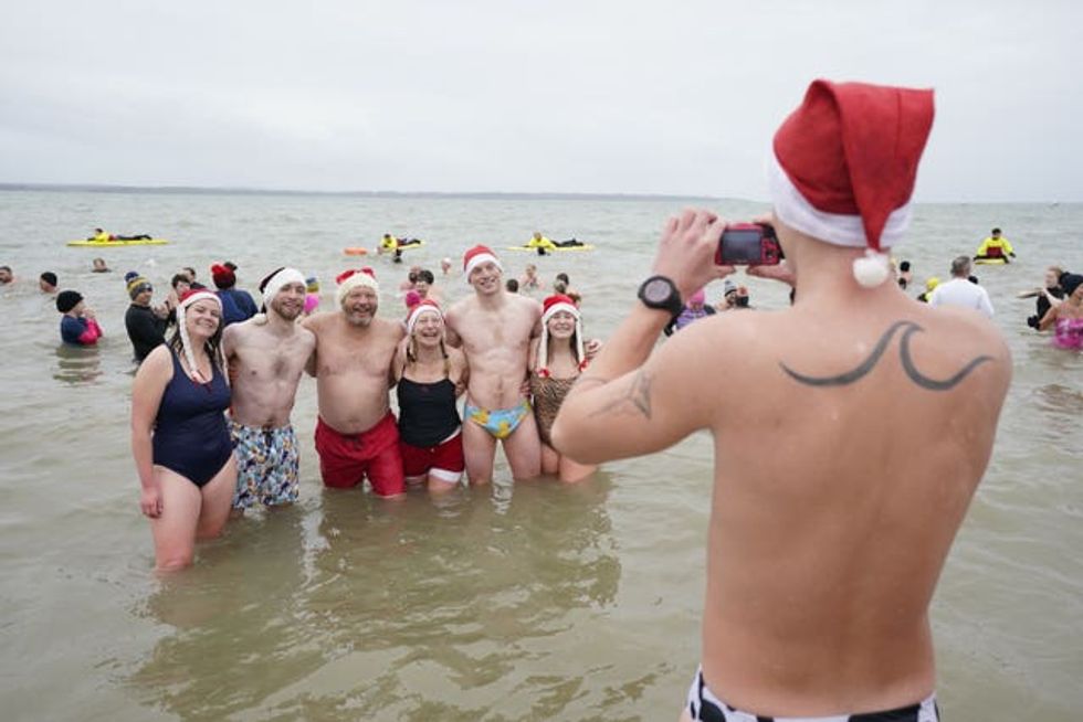 Swimmers pose for a photo during the Gosport New Year\u2019s Day Dip