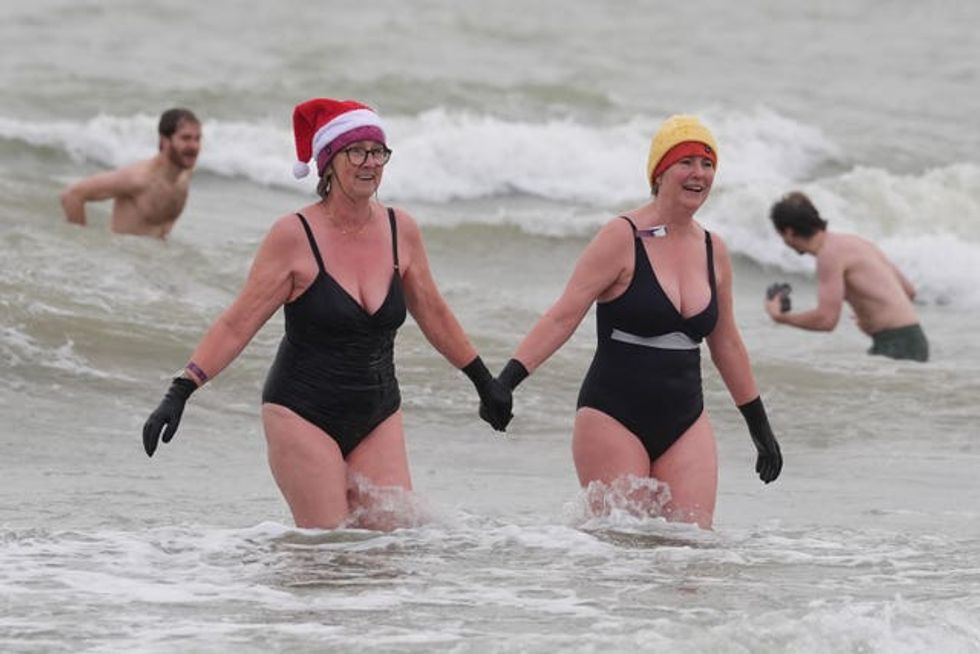 Swimmers take part in the Folkestone Lions\u2019 Boxing Day Dip at Sunny Sands Beach in Folkestone