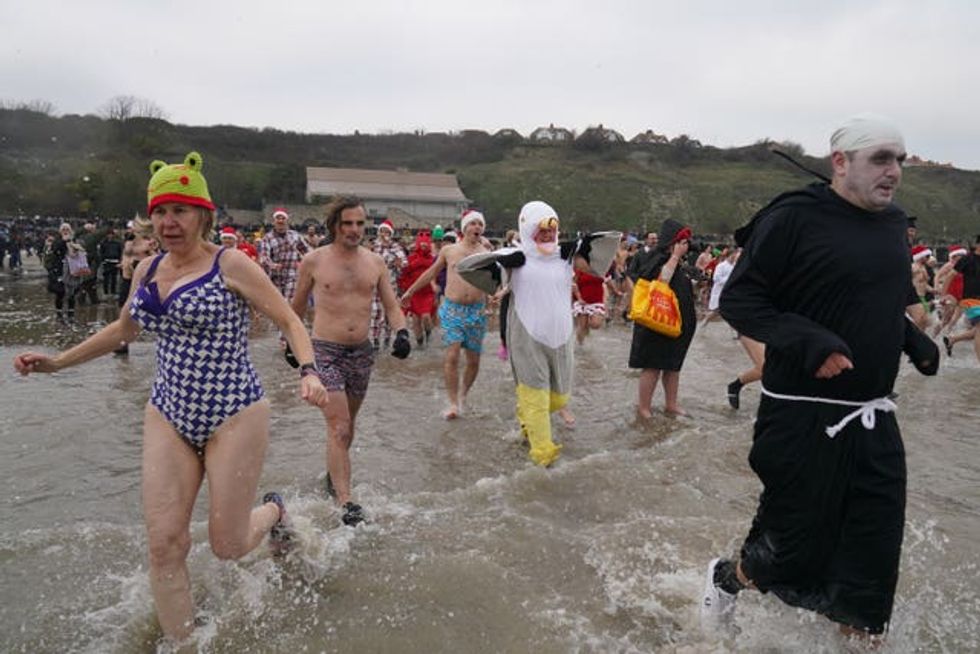 Swimmers take part in the Folkestone Lions\u2019 Boxing Day Dip at Sunny Sands Beach in Folkestone