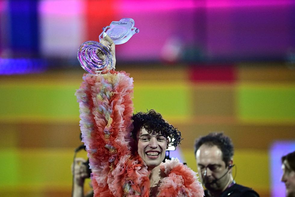Switzerland's Nemo lifts up the Eurovision trophy as winner.